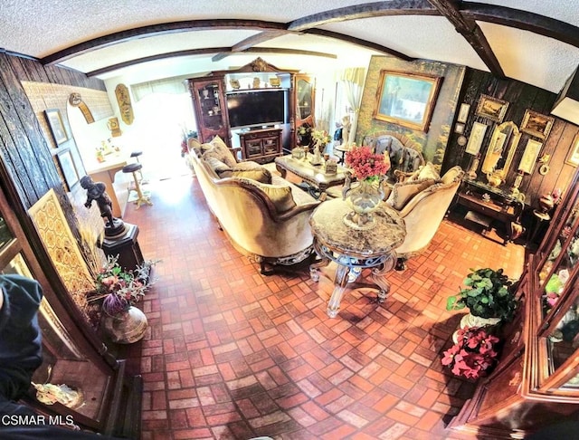 living room with beam ceiling and a textured ceiling