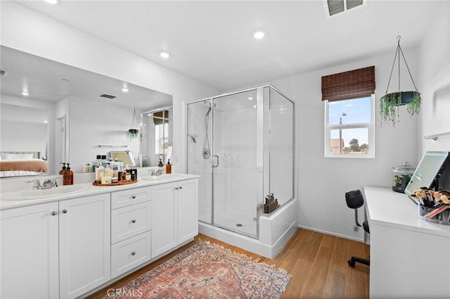 bathroom featuring vanity, hardwood / wood-style floors, and walk in shower