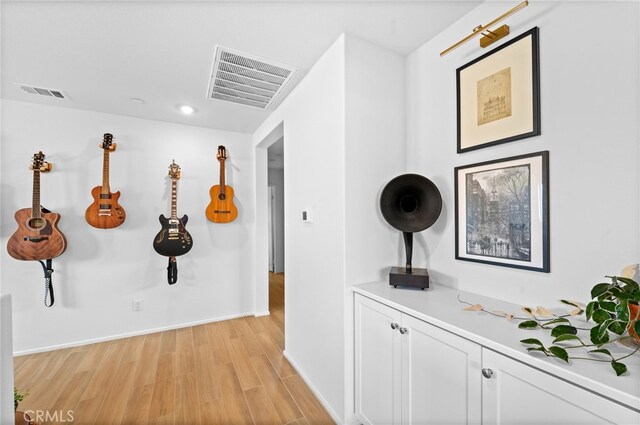 corridor with light hardwood / wood-style flooring