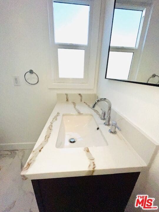 bathroom with plenty of natural light and vanity