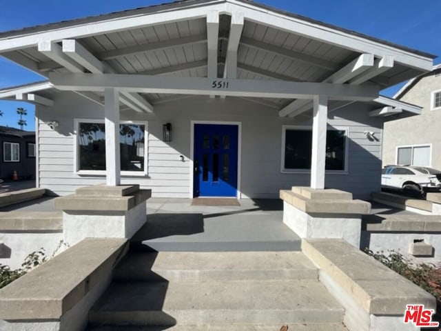 rear view of house with a porch