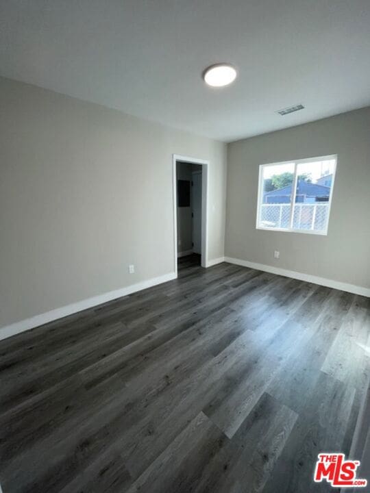 empty room featuring dark hardwood / wood-style floors