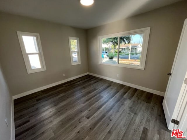 spare room with dark hardwood / wood-style floors