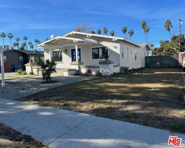 bungalow-style home with a front lawn