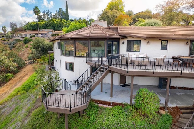 back of property with a patio area and a deck