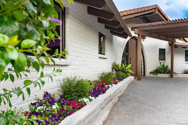 view of side of home with a pergola