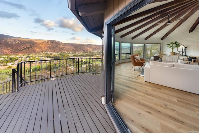 wooden terrace with a mountain view and ceiling fan