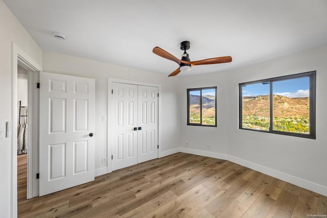 unfurnished bedroom featuring ceiling fan and hardwood / wood-style flooring