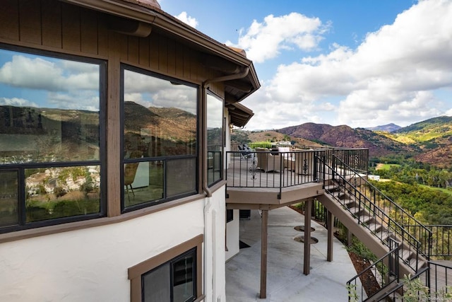 balcony featuring a mountain view and a patio area