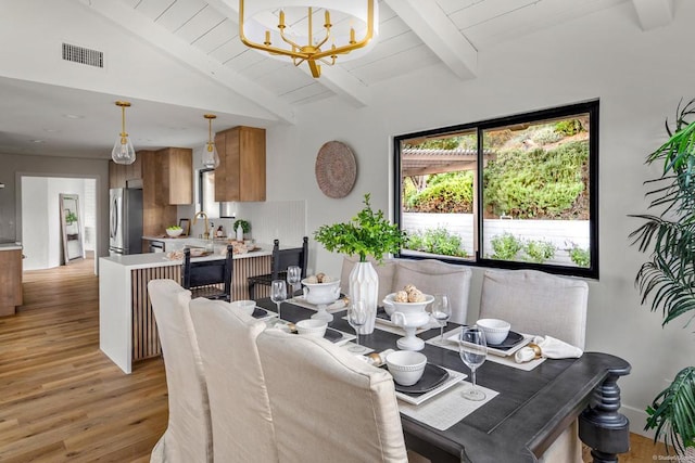 dining space with wood ceiling, a chandelier, lofted ceiling with beams, and light wood-type flooring