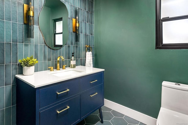 bathroom featuring tile patterned floors, vanity, and toilet