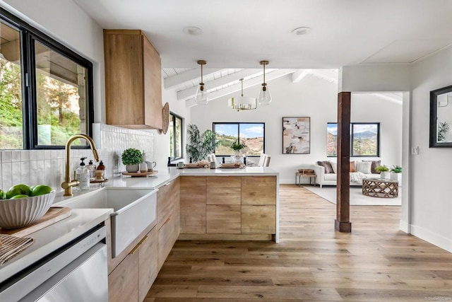 kitchen with vaulted ceiling with beams, wood-type flooring, kitchen peninsula, and decorative light fixtures