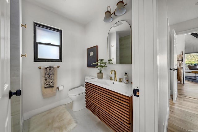 bathroom with vanity, wood-type flooring, and toilet