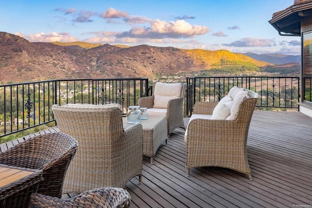 wooden terrace featuring a mountain view and an outdoor living space