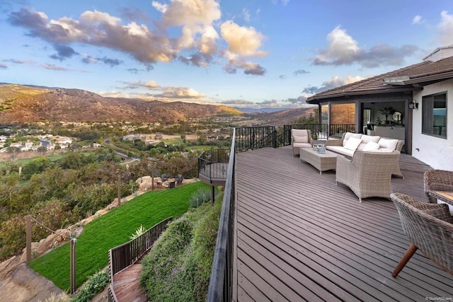 wooden terrace featuring a mountain view and an outdoor living space