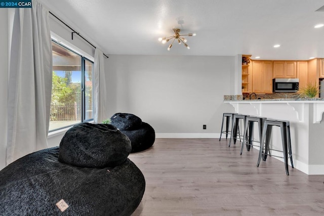 interior space with light wood-type flooring and a chandelier