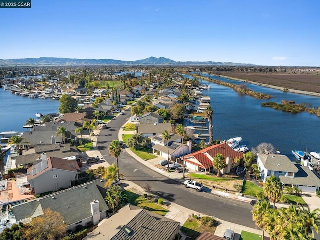 aerial view featuring a water and mountain view