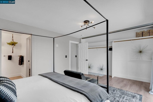 bedroom with a closet and light hardwood / wood-style flooring