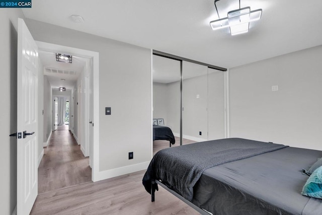 bedroom featuring a closet and light wood-type flooring