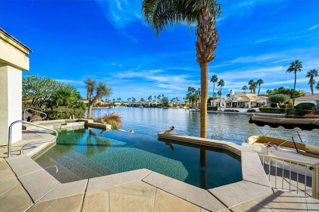 view of swimming pool with a water view