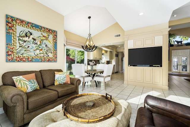 living room featuring lofted ceiling, a notable chandelier, and light tile patterned flooring