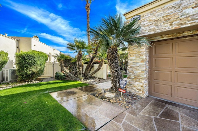 view of yard featuring a garage and ac unit