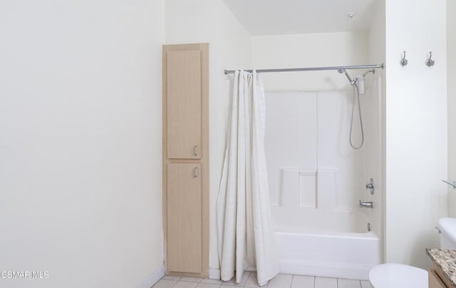 full bathroom featuring shower / bath combo with shower curtain, tile patterned floors, vanity, and toilet