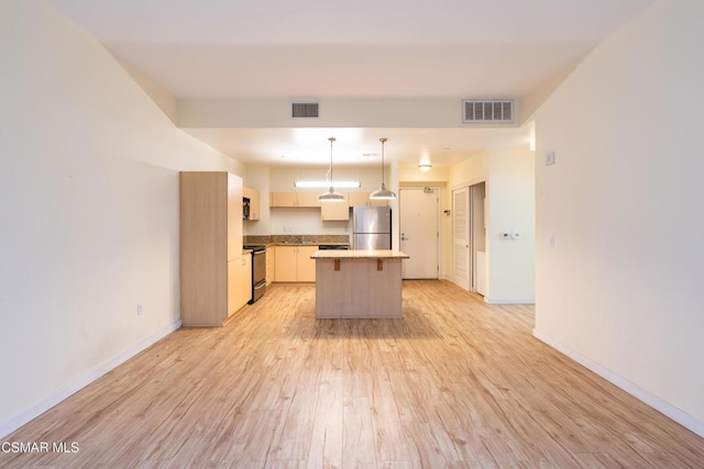 kitchen featuring black electric range, pendant lighting, a kitchen island, stainless steel refrigerator, and light hardwood / wood-style flooring