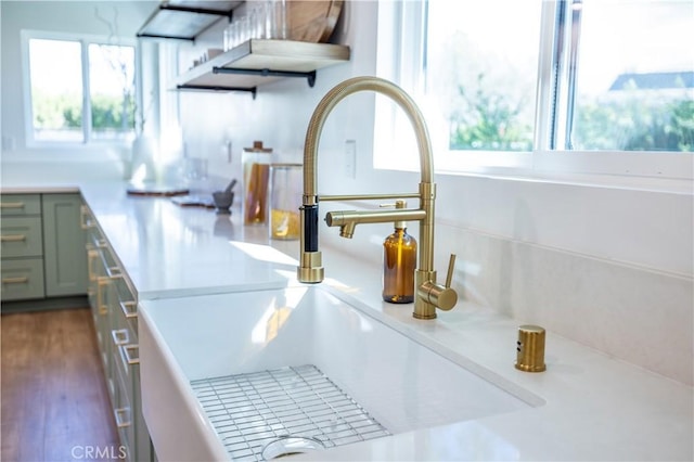 interior details with dark wood-style floors, light countertops, and a sink