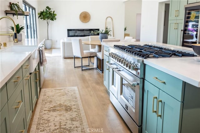 kitchen featuring light hardwood / wood-style floors and range with two ovens