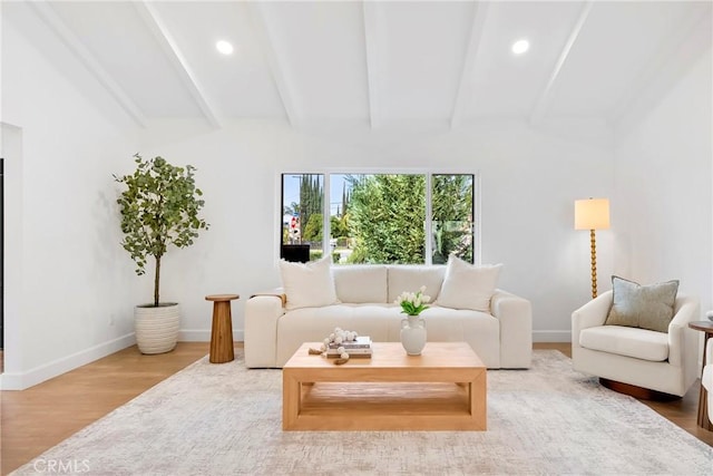 living area featuring recessed lighting, beamed ceiling, baseboards, and wood finished floors