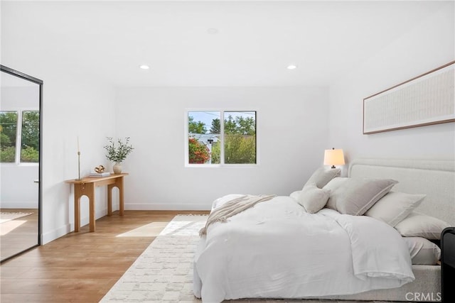 bedroom featuring recessed lighting, light wood-style flooring, and baseboards