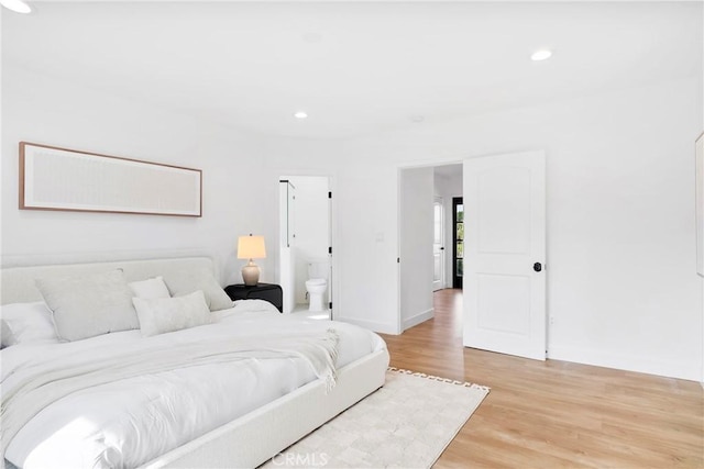 bedroom with light wood-type flooring, baseboards, and recessed lighting