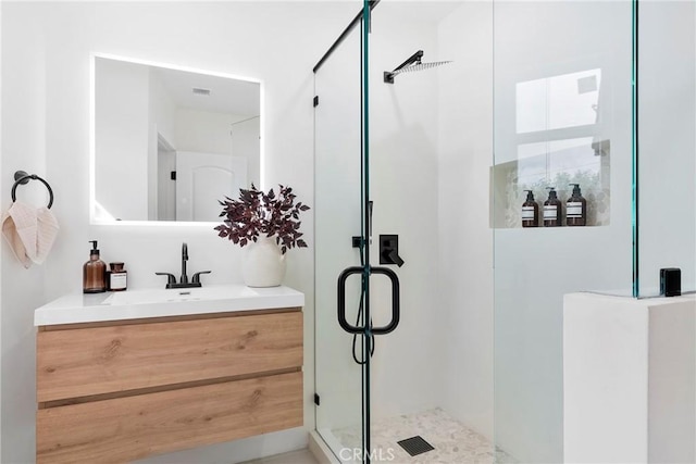 bathroom featuring a stall shower and vanity