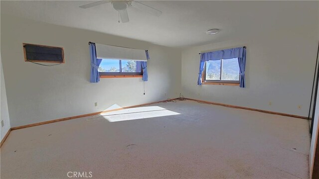 spare room with ceiling fan and carpet