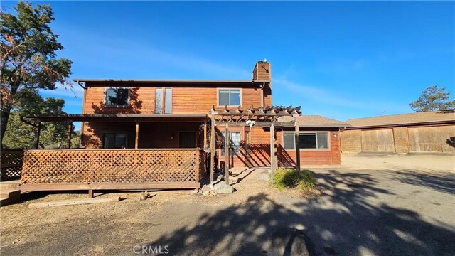 rear view of property with a pergola and a patio