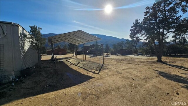 view of yard featuring a mountain view and a carport