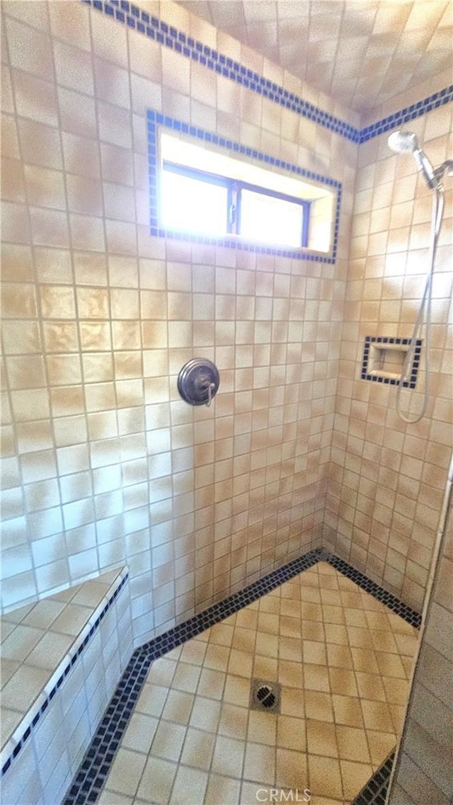 bathroom featuring tiled shower