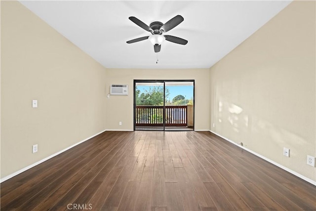 spare room featuring dark wood-type flooring, ceiling fan, and a wall mounted AC