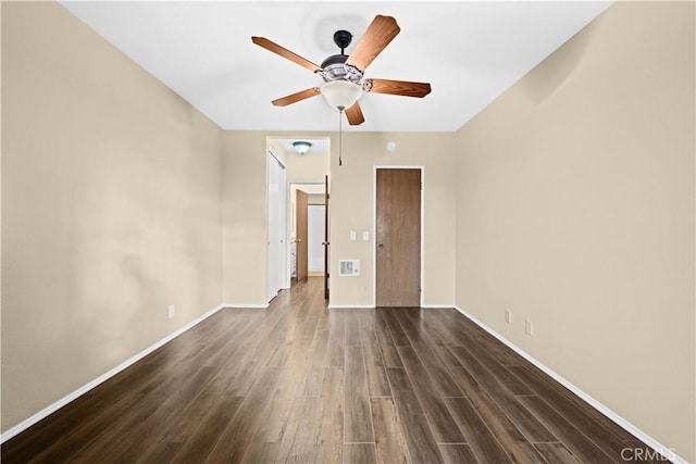 unfurnished bedroom with ceiling fan and dark hardwood / wood-style flooring