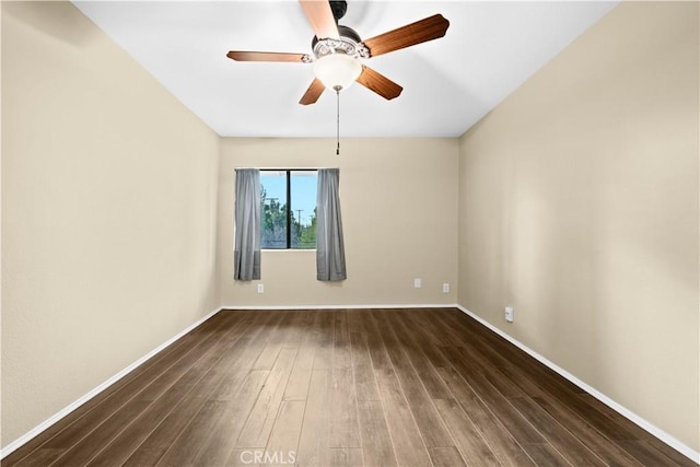 empty room featuring ceiling fan and dark hardwood / wood-style flooring