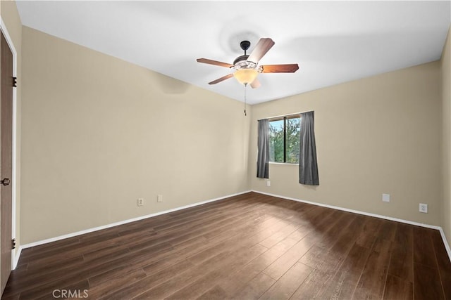 empty room featuring ceiling fan and dark hardwood / wood-style flooring