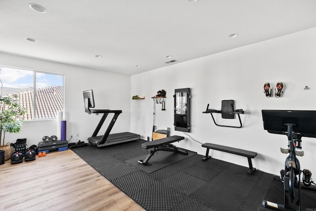 workout room with recessed lighting, visible vents, and wood finished floors