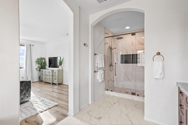 bathroom featuring marble finish floor, a marble finish shower, recessed lighting, vanity, and baseboards