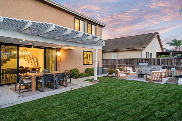 yard at dusk featuring fence, outdoor dining area, a pergola, and a patio