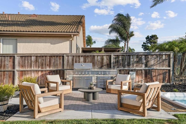 view of patio with fence and area for grilling