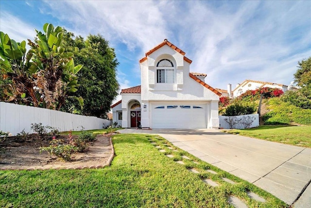 mediterranean / spanish house with a front lawn and a garage