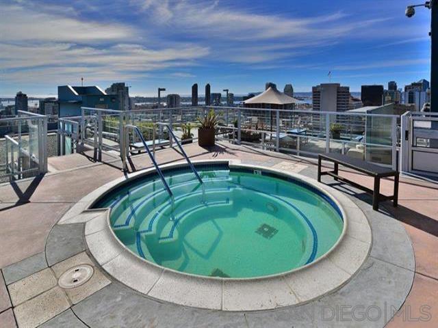 view of swimming pool featuring a community hot tub