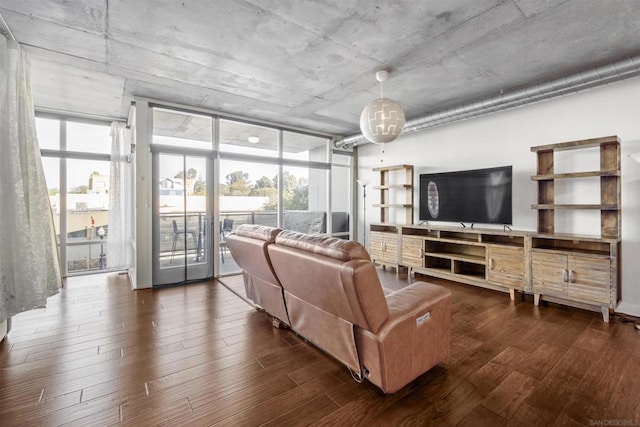 living room with floor to ceiling windows and dark wood-type flooring