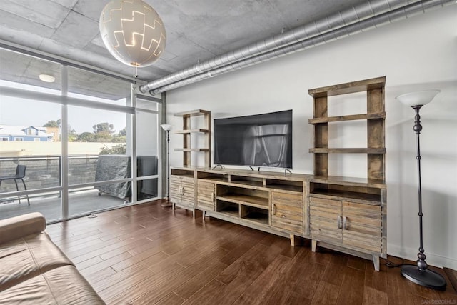 living room with floor to ceiling windows and dark hardwood / wood-style floors